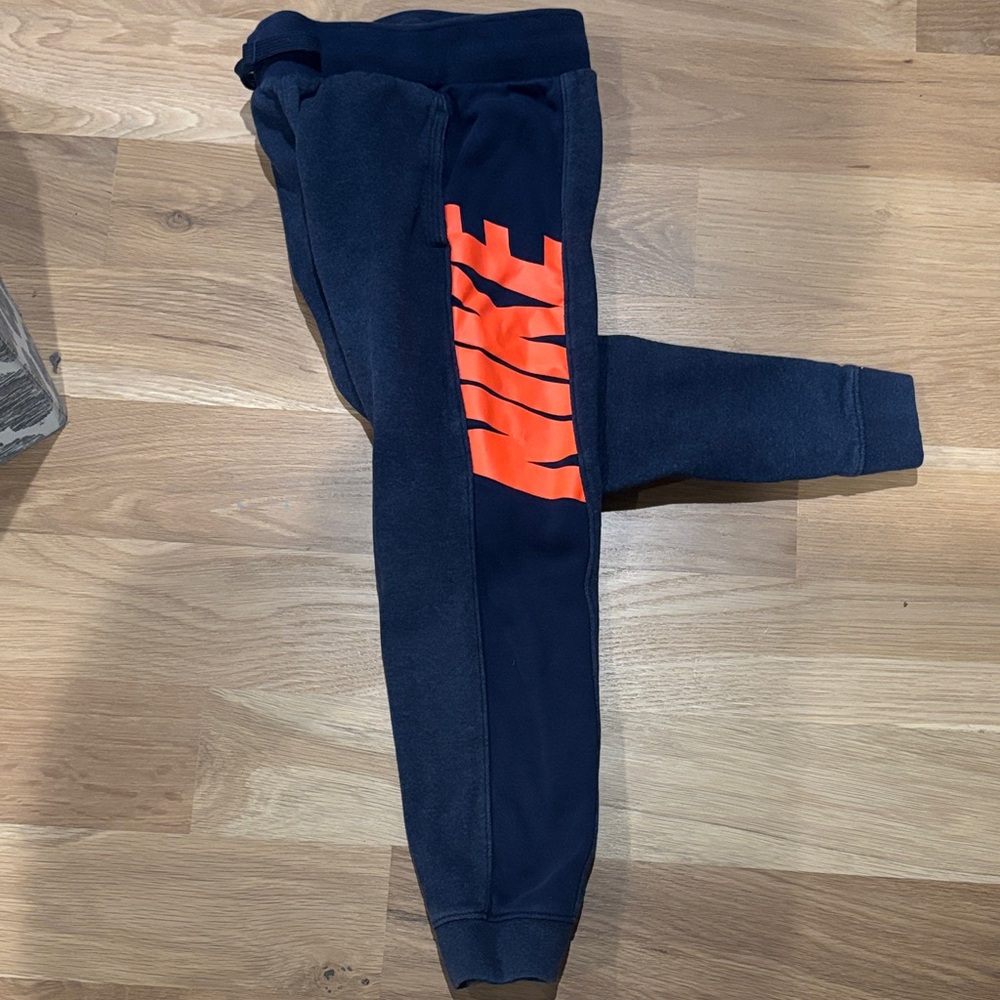 Nike Kids Dark Blue Joggers with Bright Orange Logo